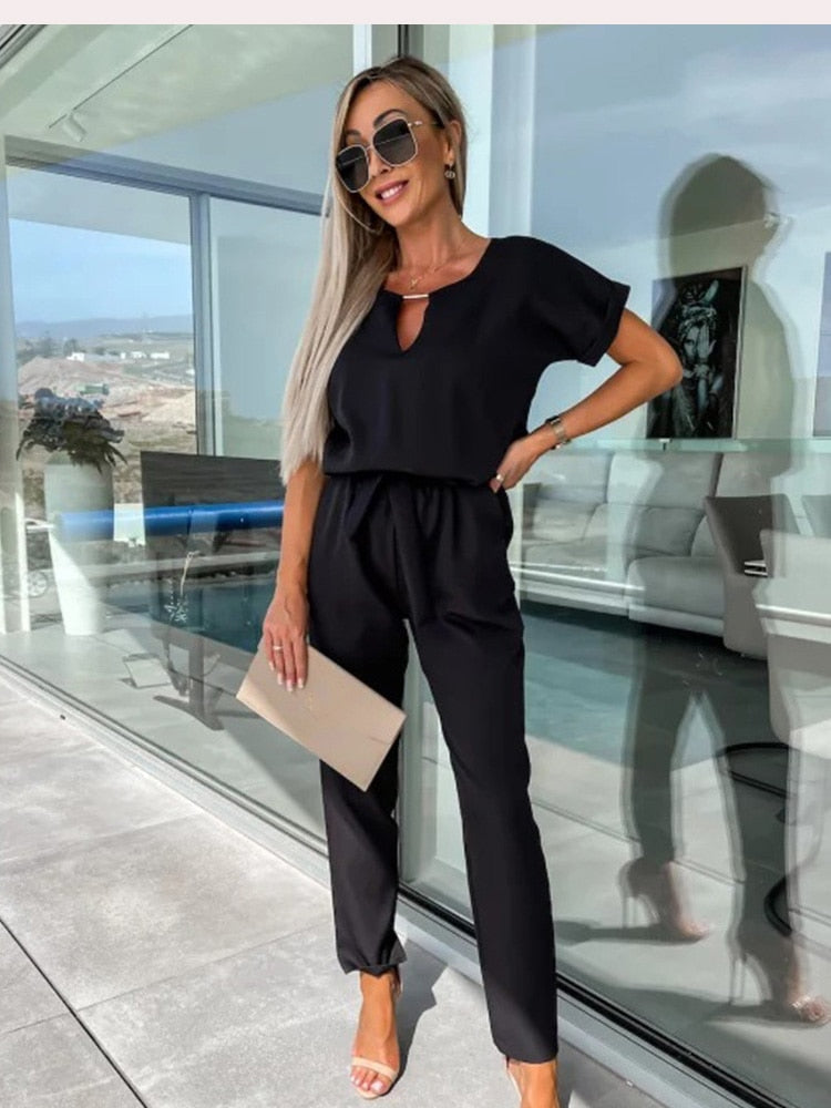 Women's elegant black jumpsuit featuring a flattering V-neckline and comfortable elastic waistband, perfect for transitioning from day to night. 9