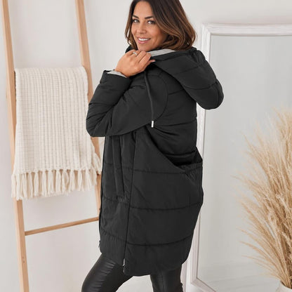 Women's longline quilted puffer jacket in black, featuring a zip front and practical pockets, ideal for cold weather wear. 3