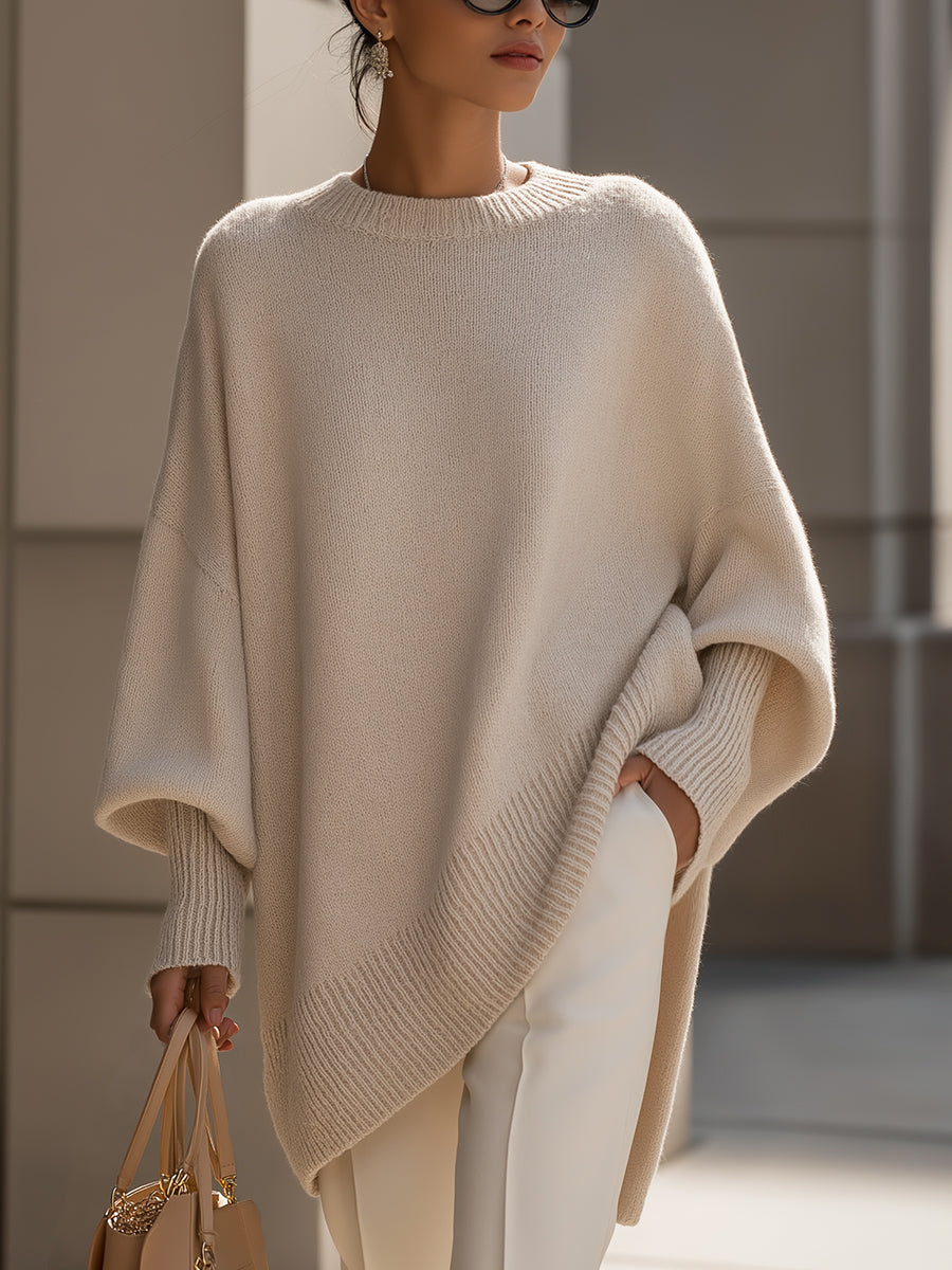 Women's oversized sweater in beige with an asymmetrical hem, made from a cozy wool blend, perfect for stylish layering and comfort in cooler weather. 0