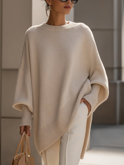 Women's oversized sweater in beige with an asymmetrical hem, made from a cozy wool blend, perfect for stylish layering and comfort in cooler weather. 0