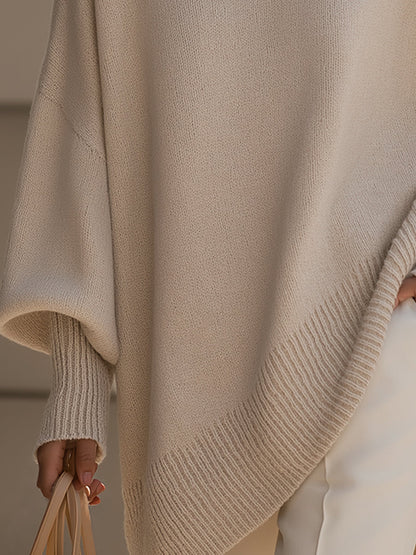 Women's oversized sweater in beige with an asymmetrical hem, made from a cozy wool blend, perfect for stylish layering and comfort in cooler weather. 2