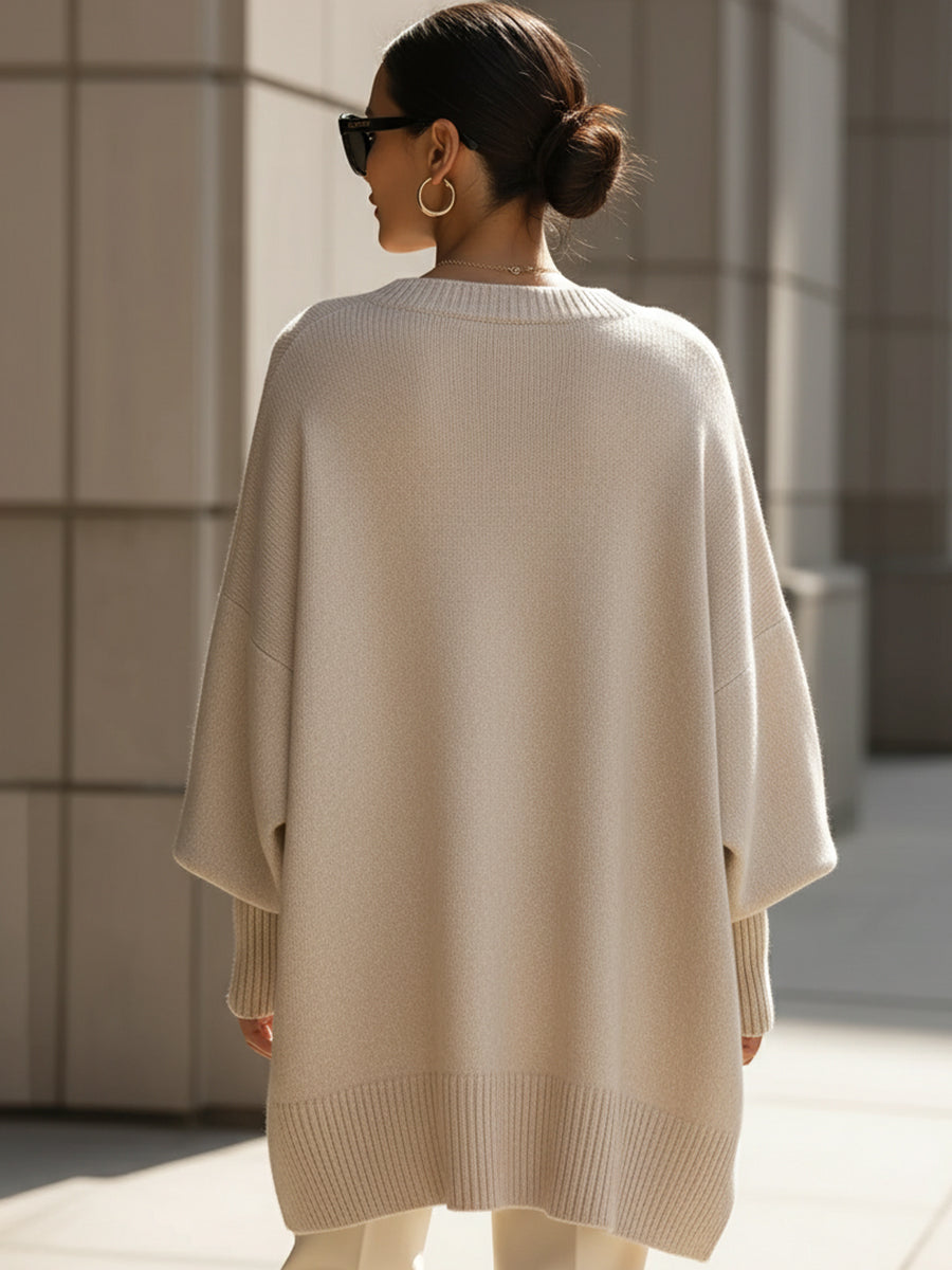 Women's oversized sweater in beige with an asymmetrical hem, made from a cozy wool blend, perfect for stylish layering and comfort in cooler weather. 3