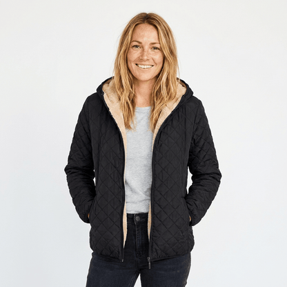 Women's quilted jacket featuring a fleece-lined hood and zip-up closure, designed for warmth and style, perfect for winter wear. 0