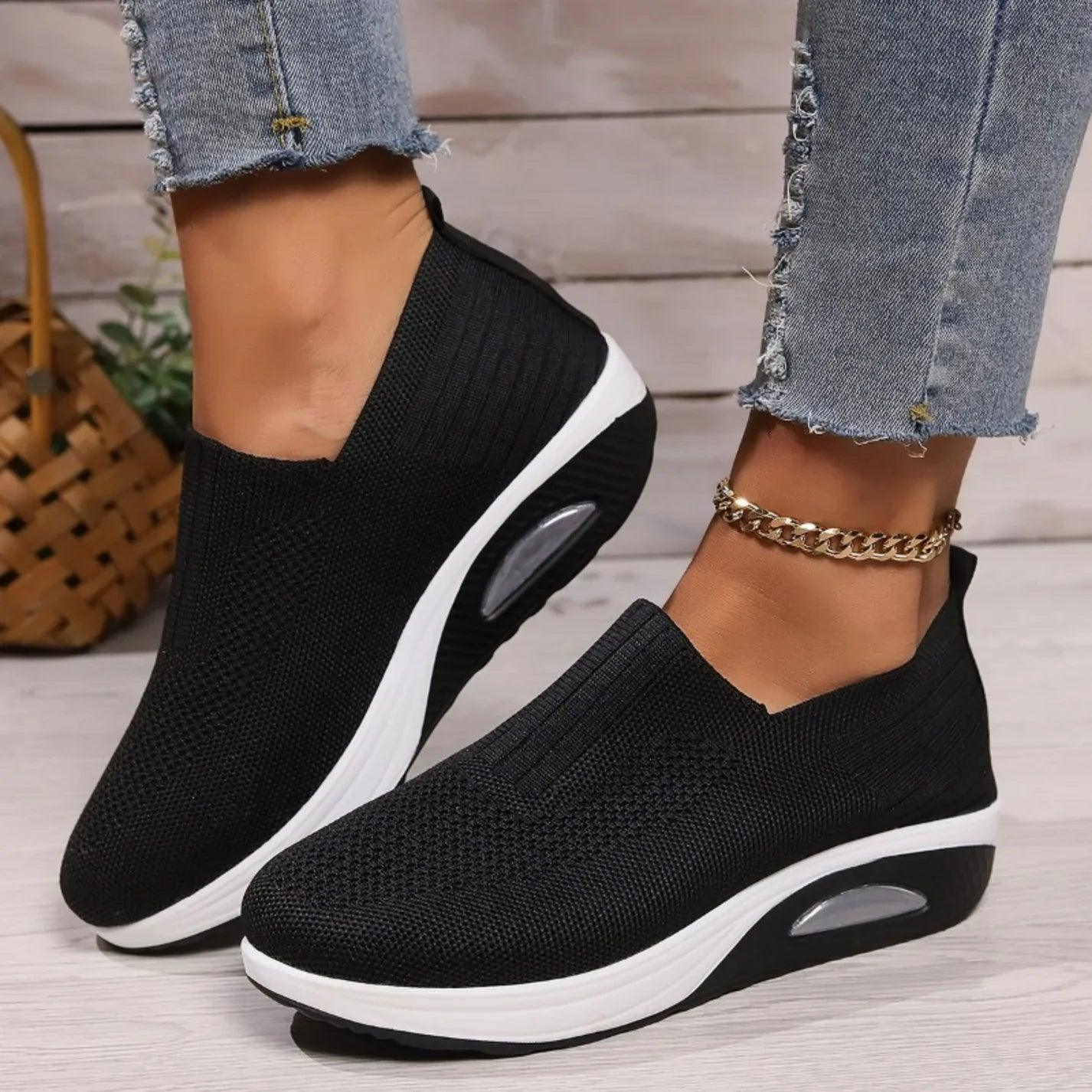 Women's slip-on sneakers in white, featuring a breathable design and flexible support, perfect for sporty minimalist style. 0