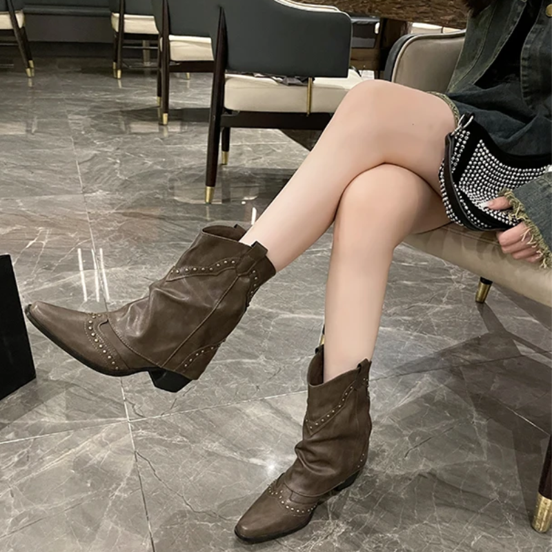Black women's studded cowboy boots featuring mid-heel and metallic accents, showcasing a stylish Western-inspired design perfect for fashionable outfits. 1