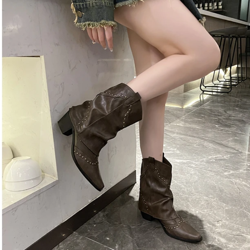 Black women's studded cowboy boots featuring mid-heel and metallic accents, showcasing a stylish Western-inspired design perfect for fashionable outfits. 2
