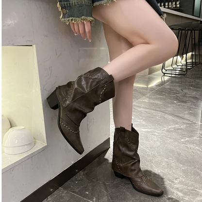 Black women's studded cowboy boots featuring mid-heel and metallic accents, showcasing a stylish Western-inspired design perfect for fashionable outfits. 2