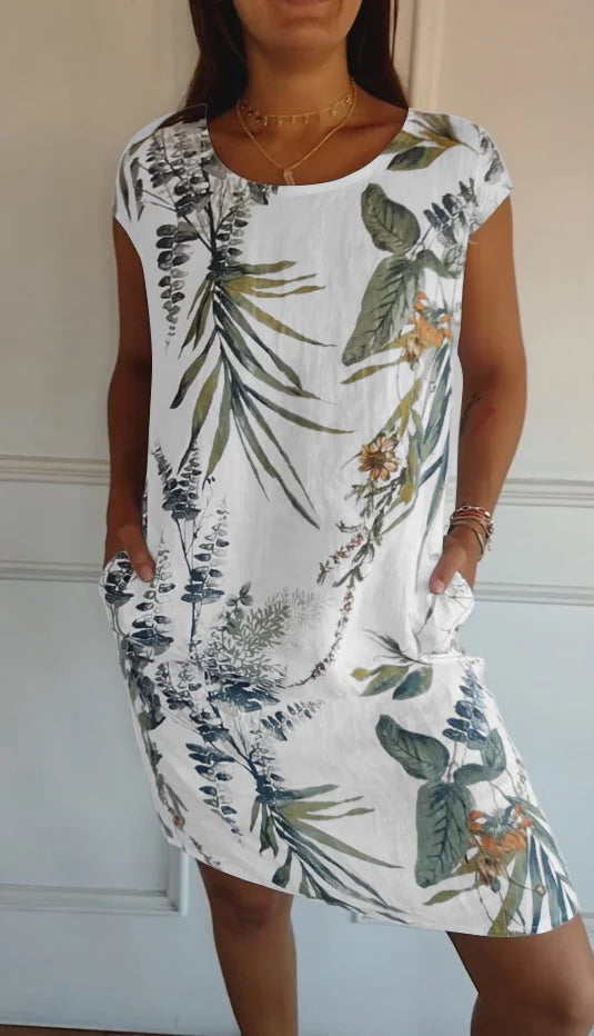 Women's summer dress featuring a vibrant botanical print, designed with convenient pockets, made from a lightweight cotton-linen blend for a relaxed fit, perfect for warm 0