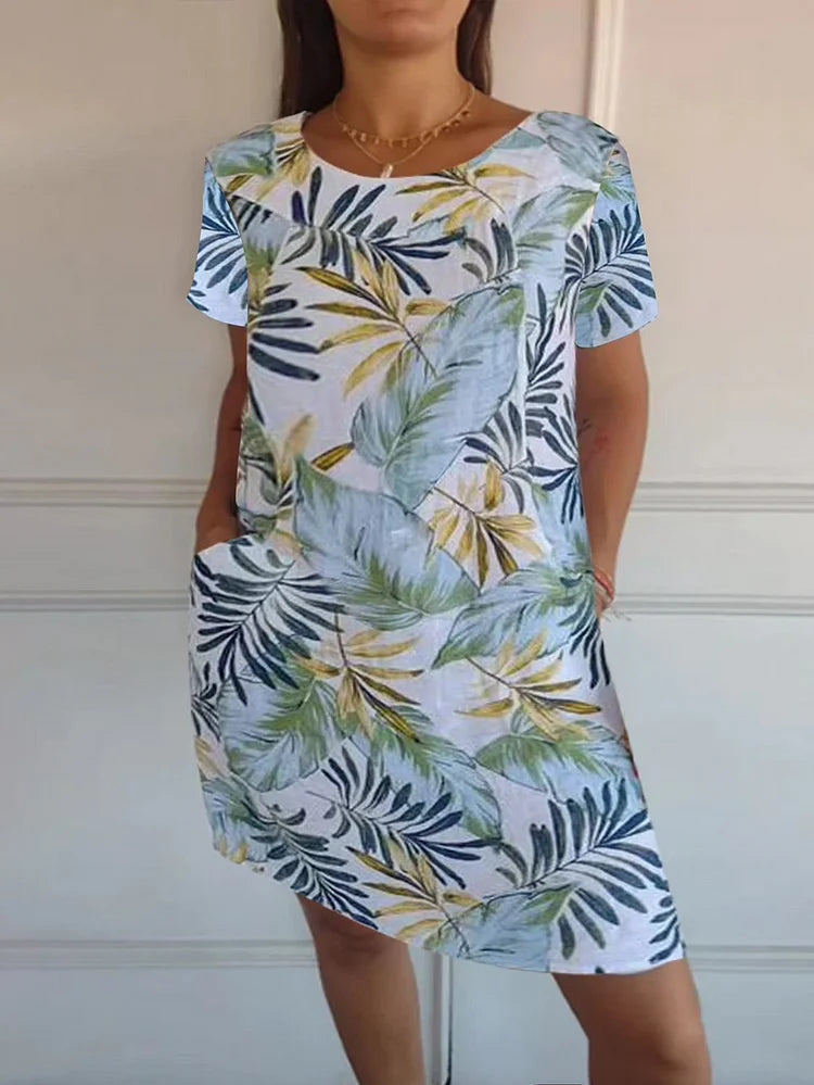 Women's summer dress featuring a vibrant botanical print, designed with convenient pockets, made from a lightweight cotton-linen blend for a relaxed fit, perfect for warm 10