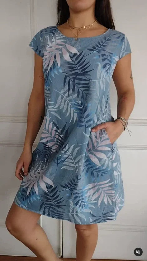 Women's summer dress featuring a vibrant botanical print, designed with convenient pockets, made from a lightweight cotton-linen blend for a relaxed fit, perfect for warm 11