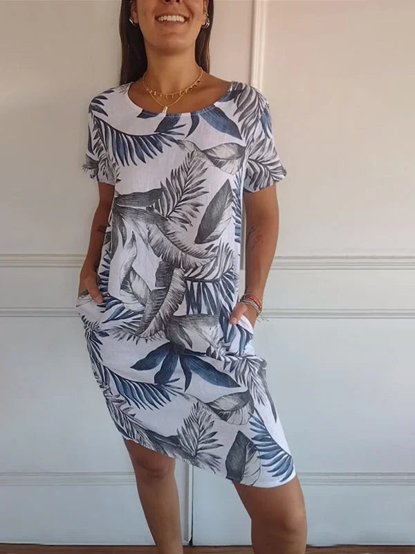 Women's summer dress featuring a vibrant botanical print, designed with convenient pockets, made from a lightweight cotton-linen blend for a relaxed fit, perfect for warm 2