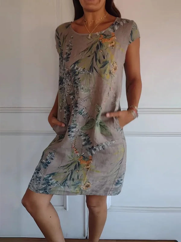 Women's summer dress featuring a vibrant botanical print, designed with convenient pockets, made from a lightweight cotton-linen blend for a relaxed fit, perfect for warm 3
