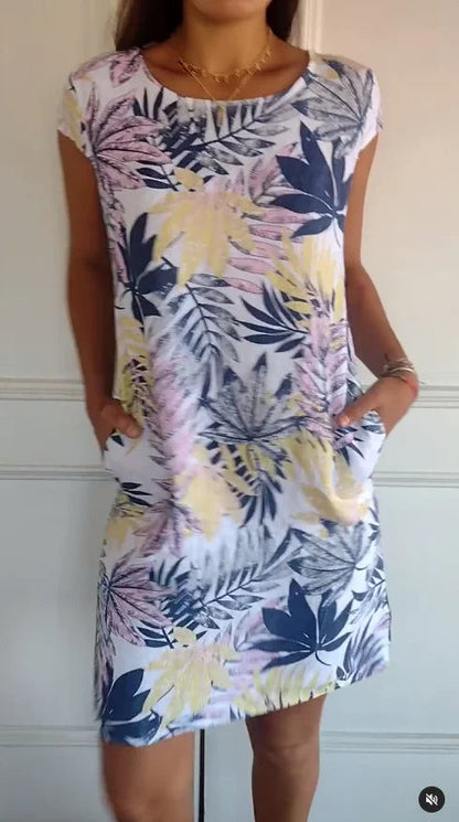 Women's summer dress featuring a vibrant botanical print, designed with convenient pockets, made from a lightweight cotton-linen blend for a relaxed fit, perfect for warm 9