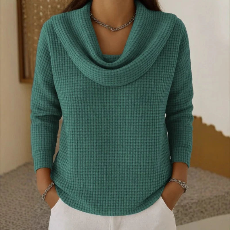 Women's blue sweater featuring a cowl neck design, made from soft waffle knit fabric for cozy warmth, with an elegant flowing fit perfect for stylish layering. 2
