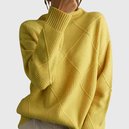 Women’s rose-colored sweater featuring a stylish geometric pattern and a cozy turtleneck design, perfect for comfortable layering in cooler weather. 11