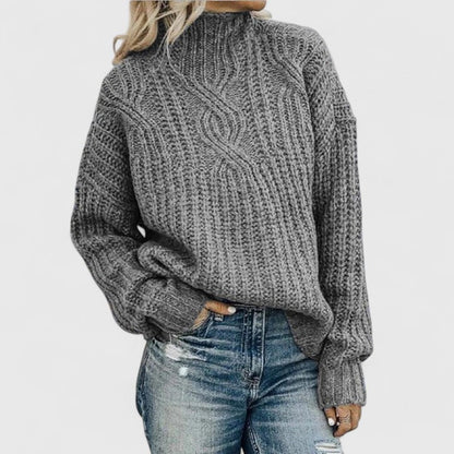 Women's cozy green sweater featuring a relaxed fit and classic cable knit design, perfect for transitional weather. 2