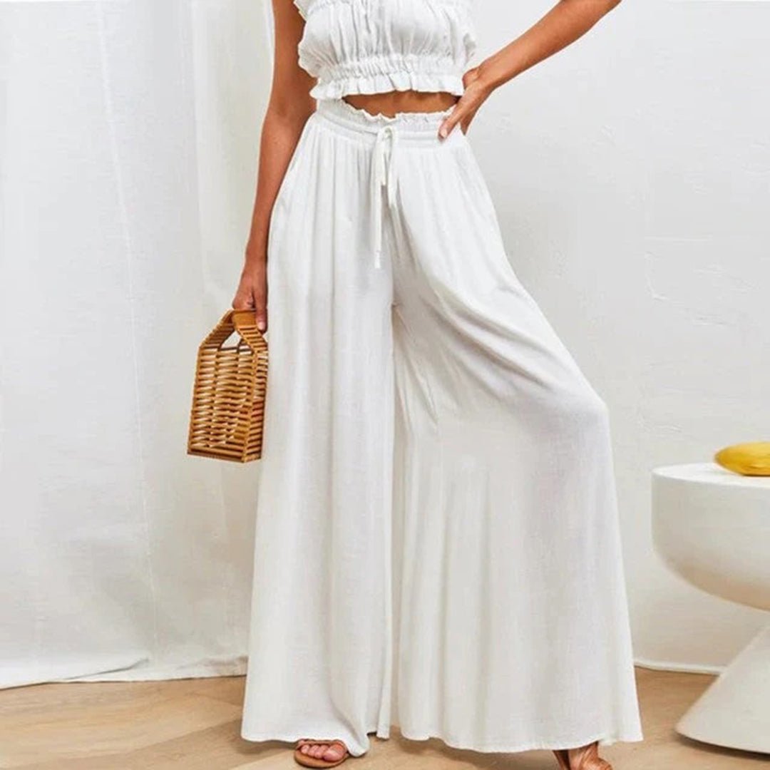 Women's wide leg pants featuring a high waist and drawstring tie, designed in a lightweight and breathable palazzo style, perfect for comfort and effortless elegance. 1