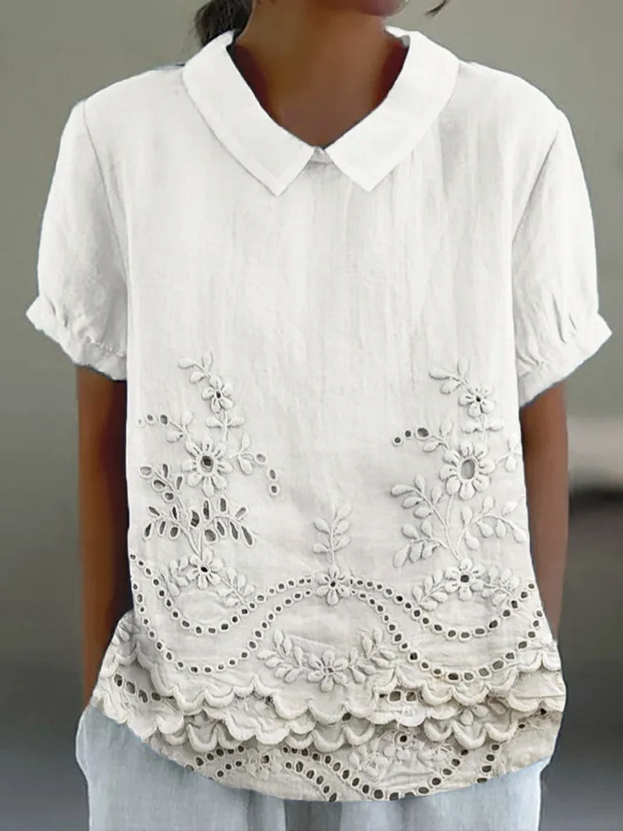 Womens blouse featuring delicate floral embroidery in a soft pink cotton linen blend with a relaxed fit. 1