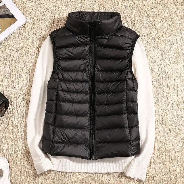 Lightweight women's gilet featuring windproof protection and a fitted design, perfect for layering and outdoor activities. 0