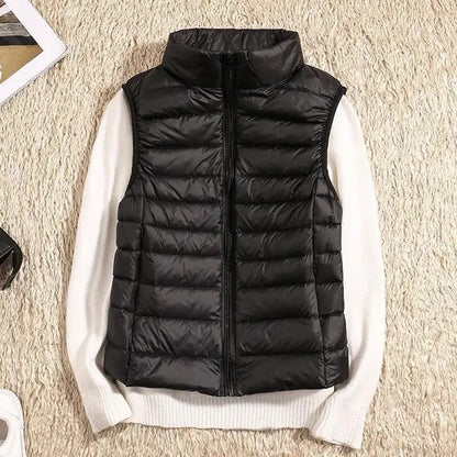 Lightweight women's gilet featuring windproof protection and a fitted design, perfect for layering and outdoor activities. 0
