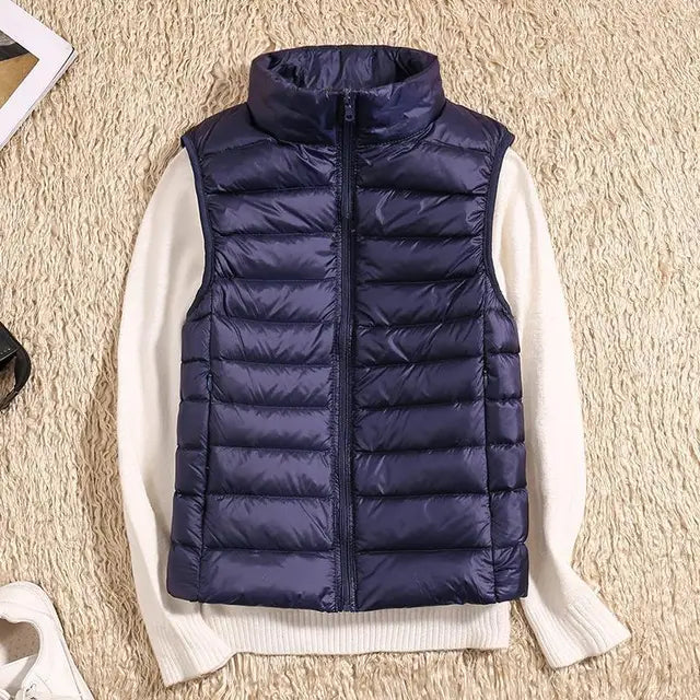 Lightweight women's gilet featuring windproof protection and a fitted design, perfect for layering and outdoor activities. 11