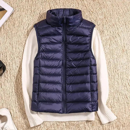 Lightweight women's gilet featuring windproof protection and a fitted design, perfect for layering and outdoor activities. 11