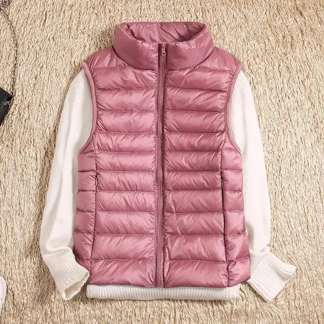 Lightweight women's gilet featuring windproof protection and a fitted design, perfect for layering and outdoor activities. 5