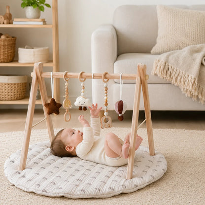 Wooden baby play gym featuring a natural wood frame and a colorful rainbow activity mat, designed for tummy time with detachable sensory toys for enhanced play and development 0