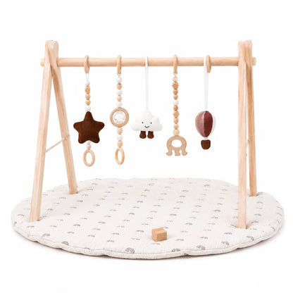 Wooden baby play gym featuring a natural wood frame and a colorful rainbow activity mat, designed for tummy time with detachable sensory toys for enhanced play and development 1
