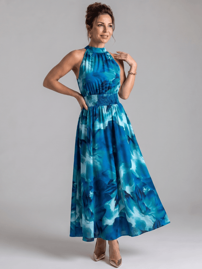 Abstract print midi dress featuring a halter neckline and defined waist, designed with lightweight, flowing fabric for a comfortable and stylish look. 5