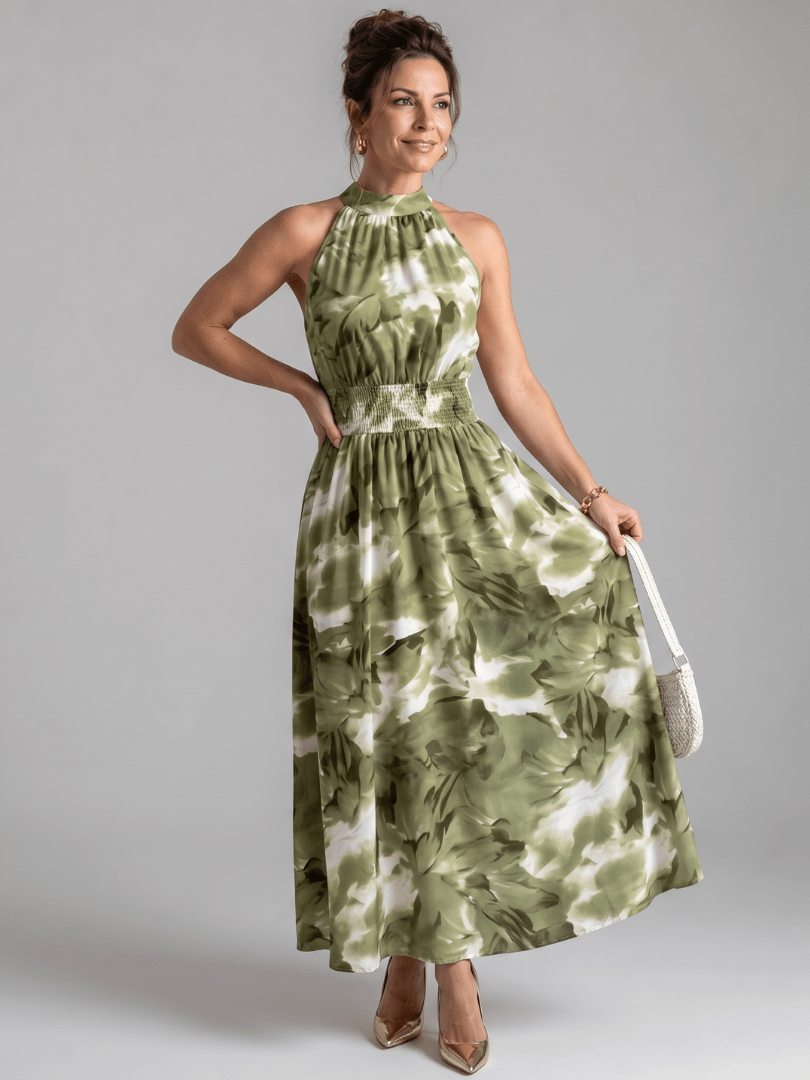Abstract print midi dress featuring a halter neckline and defined waist, designed with lightweight, flowing fabric for a comfortable and stylish look. 0