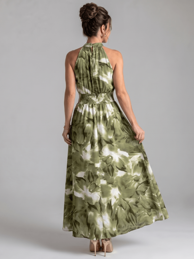 Abstract print midi dress featuring a halter neckline and defined waist, designed with lightweight, flowing fabric for a comfortable and stylish look. 3