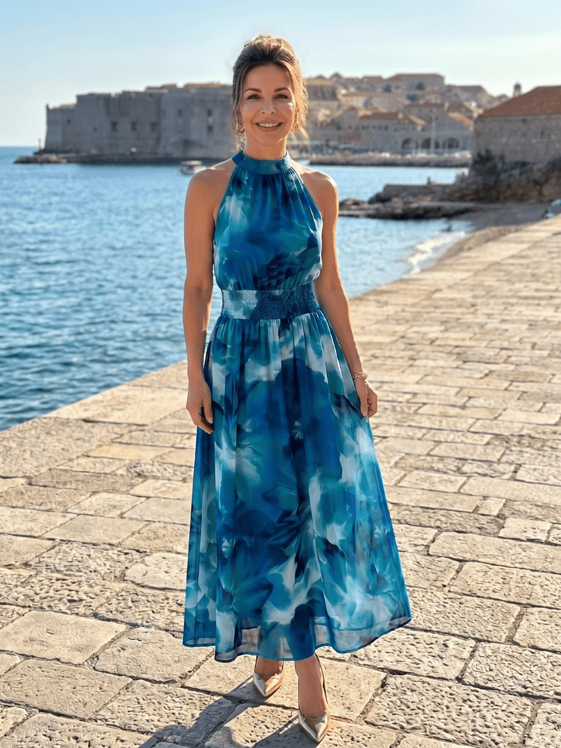 Abstract print midi dress featuring a halter neckline and defined waist, designed with lightweight, flowing fabric for a comfortable and stylish look. 6