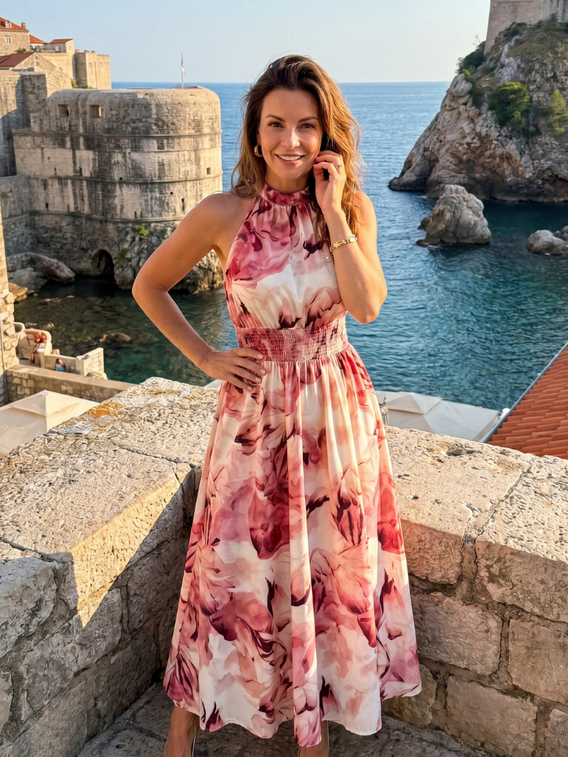 Abstract print midi dress featuring a halter neckline and defined waist, designed with lightweight, flowing fabric for a comfortable and stylish look. 8