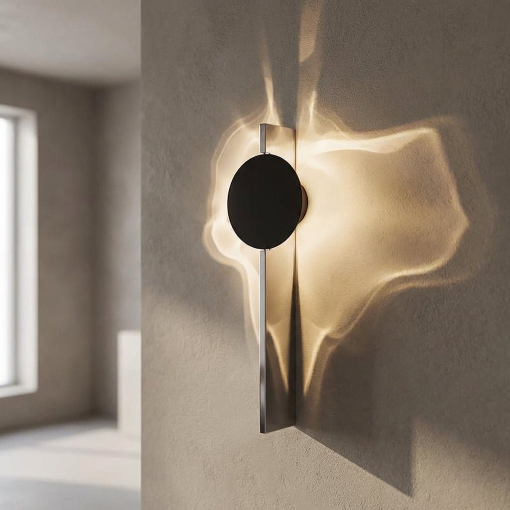 Abstract wall lamp featuring a sculptural metal design and integrated LED lighting, casting unique shadow patterns on the wall. 1