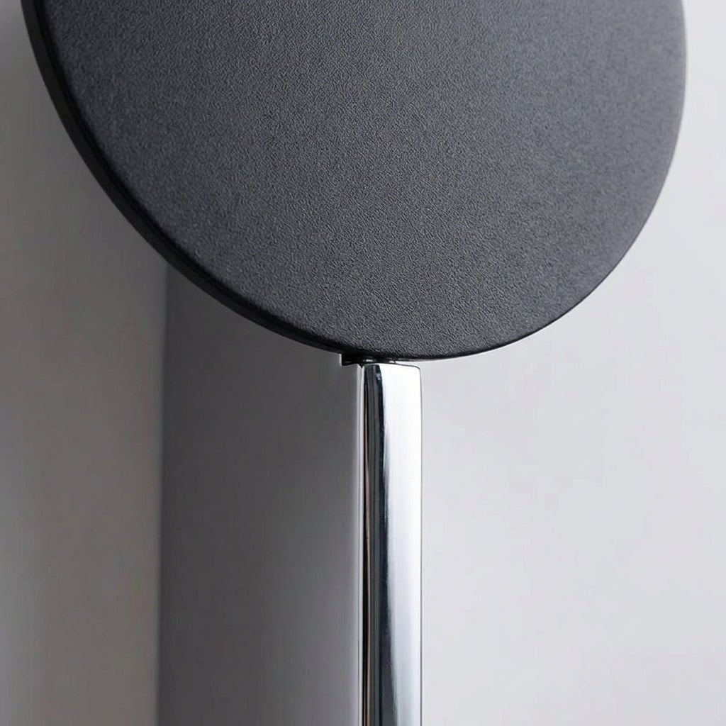 Abstract wall lamp featuring a sculptural metal design and integrated LED lighting, casting unique shadow patterns on the wall. 3