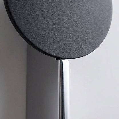 Abstract wall lamp featuring a sculptural metal design and integrated LED lighting, casting unique shadow patterns on the wall. 3