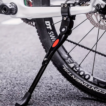 Adjustable aluminum bicycle stand for stable parking, designed to accommodate various bike sizes with a durable kickstand. 0