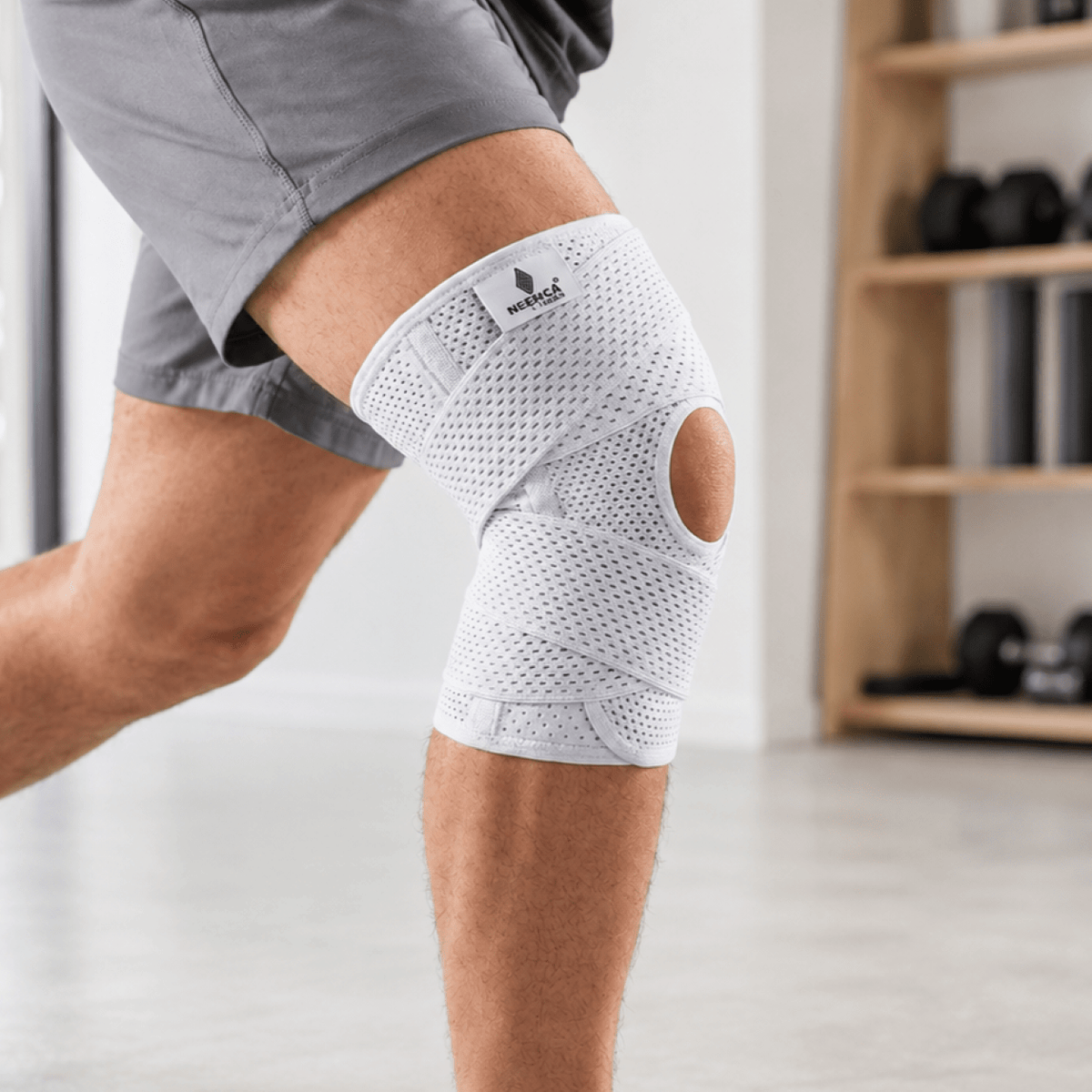 Adjustable knee support brace with dual side stabilizers made from breathable polyester for enhanced stability and comfort during physical activities. 1