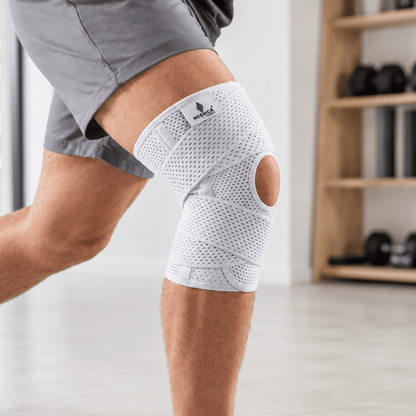Adjustable knee support brace with dual side stabilizers made from breathable polyester for enhanced stability and comfort during physical activities. 1