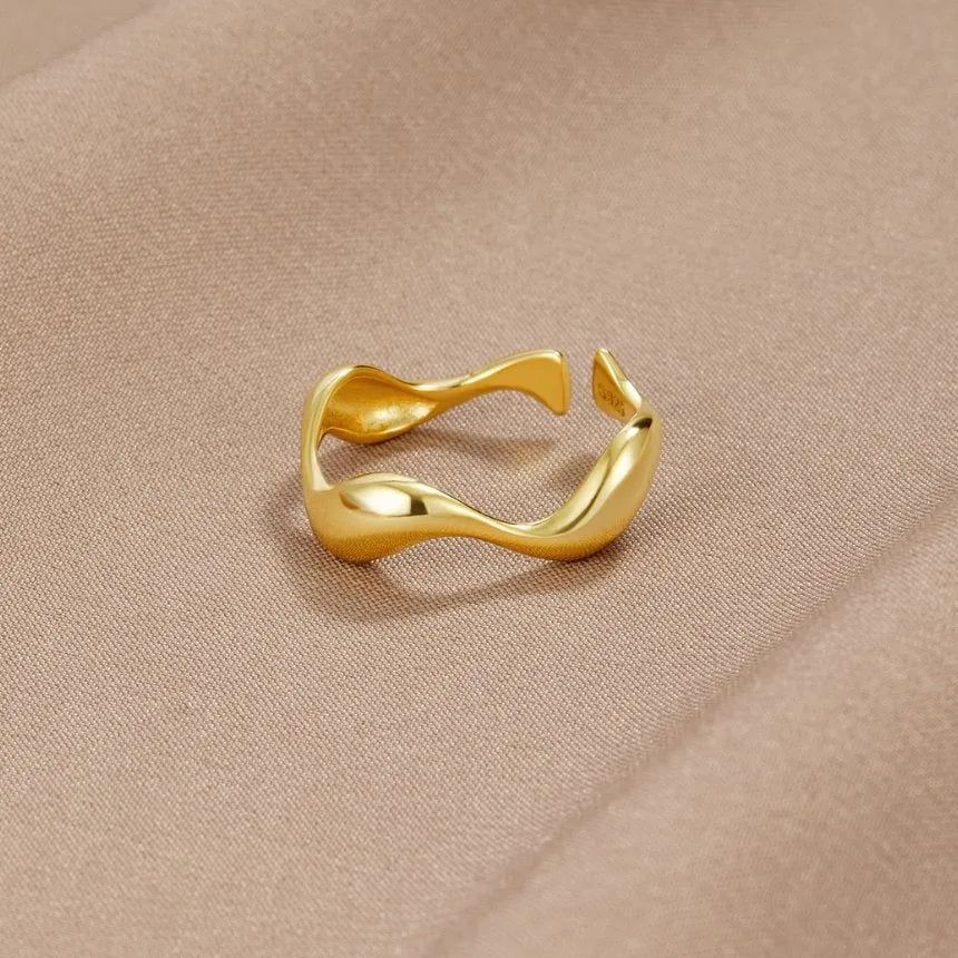 Adjustable minimalist ring in 18K gold plated sterling silver featuring an ocean-inspired design, perfect for elegant and modern jewelry collections. 0