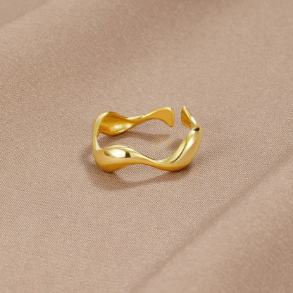Adjustable minimalist ring in 18K gold plated sterling silver featuring an ocean-inspired design, perfect for elegant and modern jewelry collections. 0