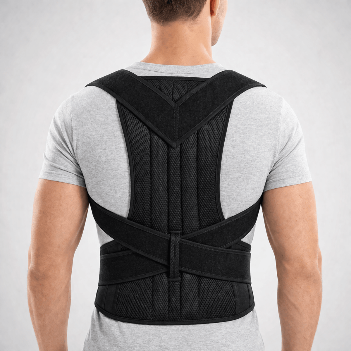 Adjustable posture corrector brace with lumbar support, featuring a breathable design for enhanced back support and comfort. 1