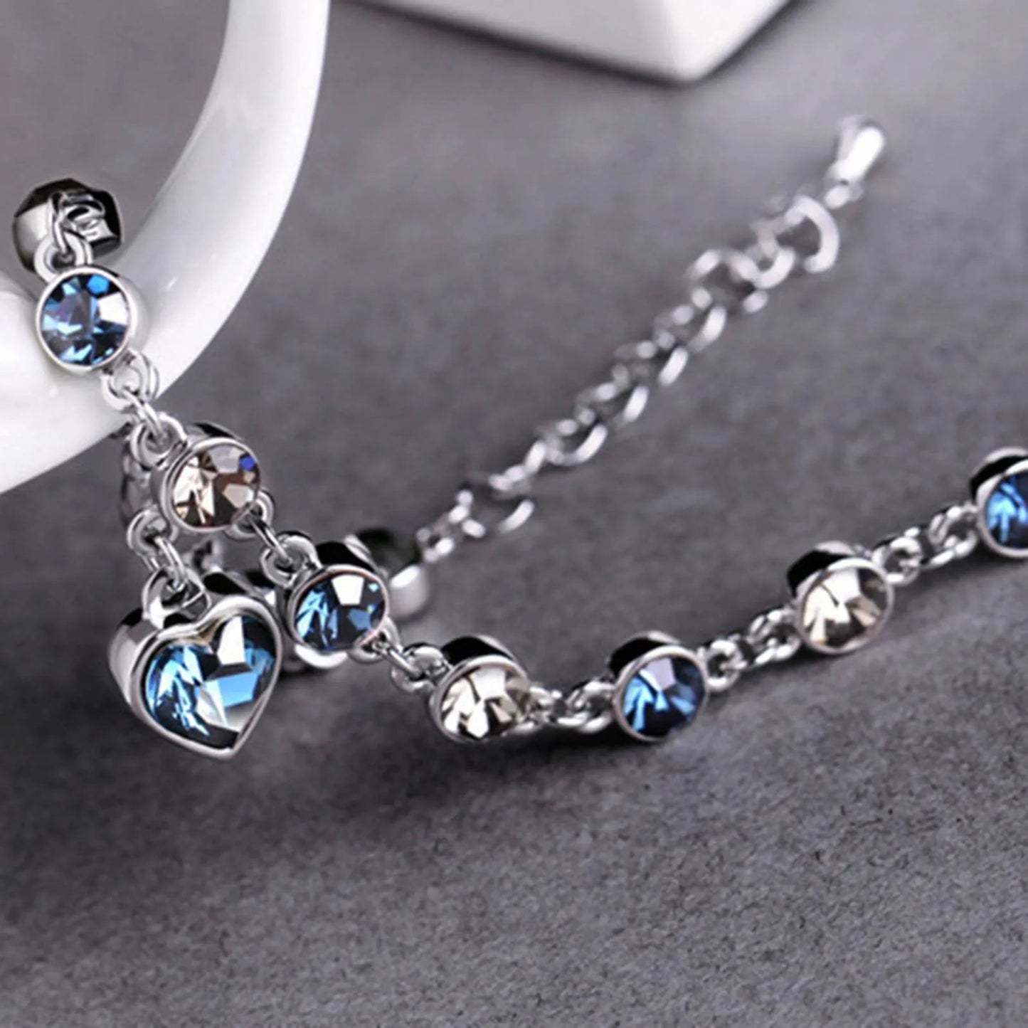 Adjustable sterling silver bracelet featuring azure cubic zirconia stones, designed with an ocean-inspired motif for comfortable wear. 4