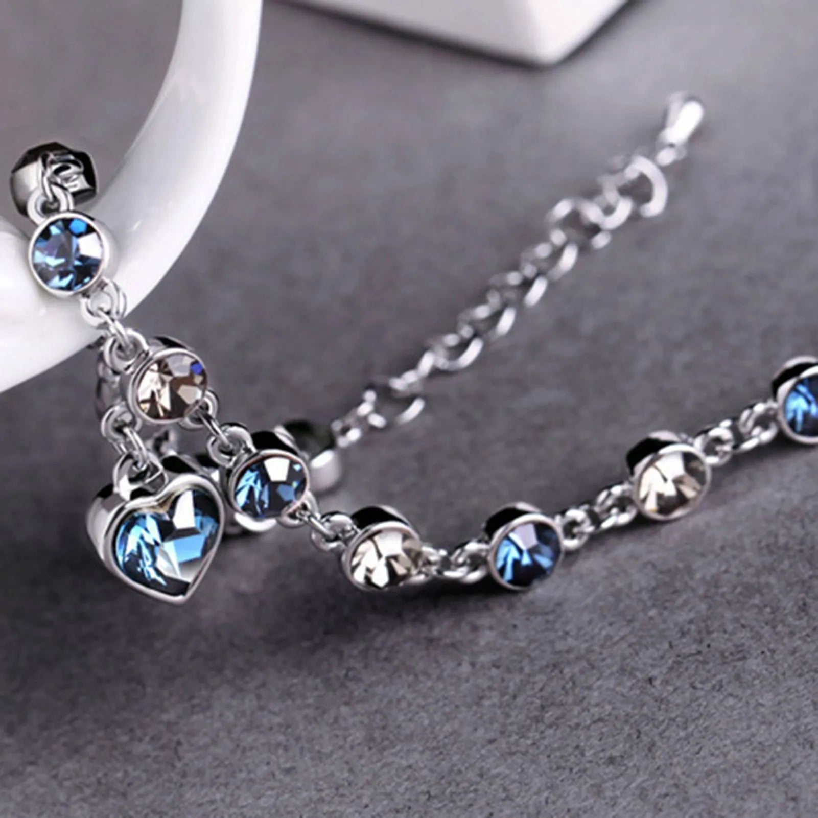 Adjustable sterling silver bracelet featuring azure cubic zirconia stones, designed with an ocean-inspired motif for comfortable wear. 4