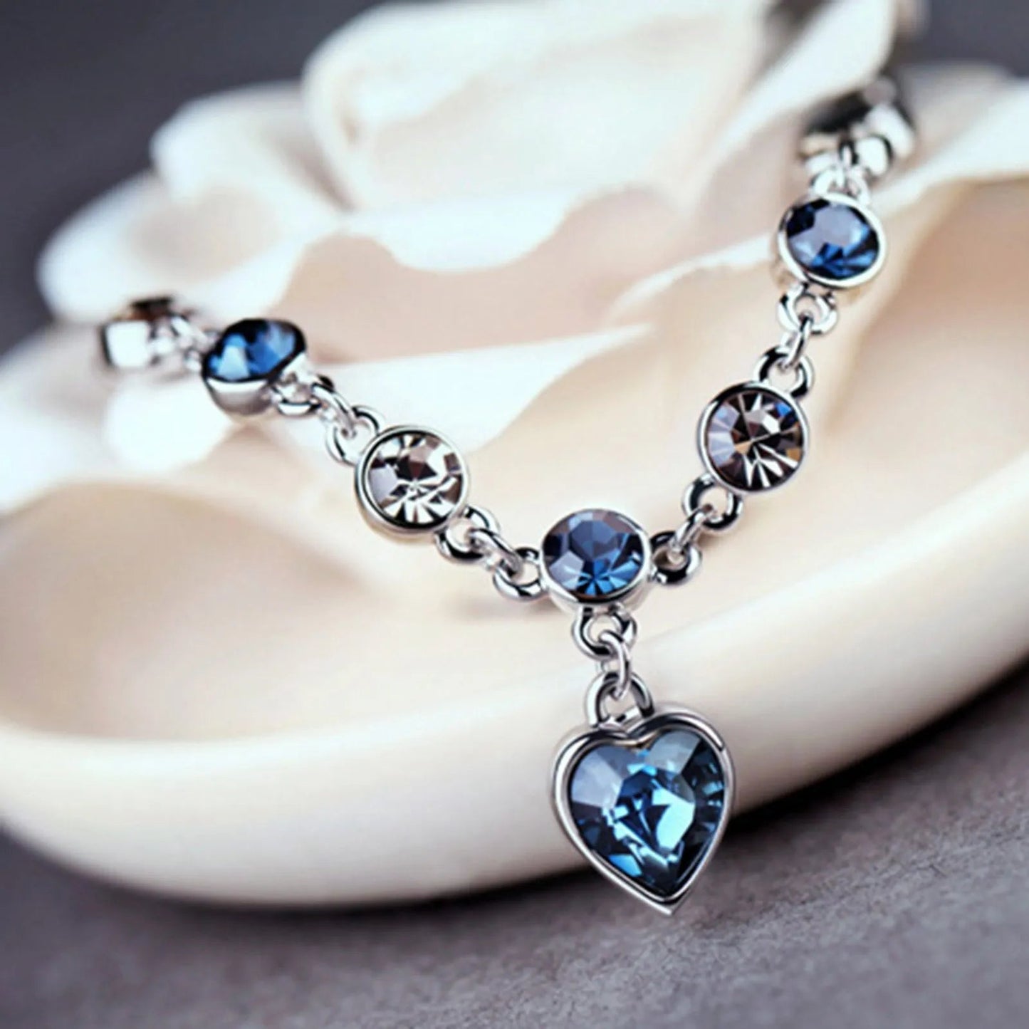 Adjustable sterling silver bracelet featuring azure cubic zirconia stones, designed with an ocean-inspired motif for comfortable wear. 2