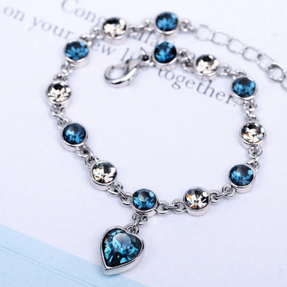 Adjustable sterling silver bracelet featuring azure cubic zirconia stones, designed with an ocean-inspired motif for comfortable wear. 1