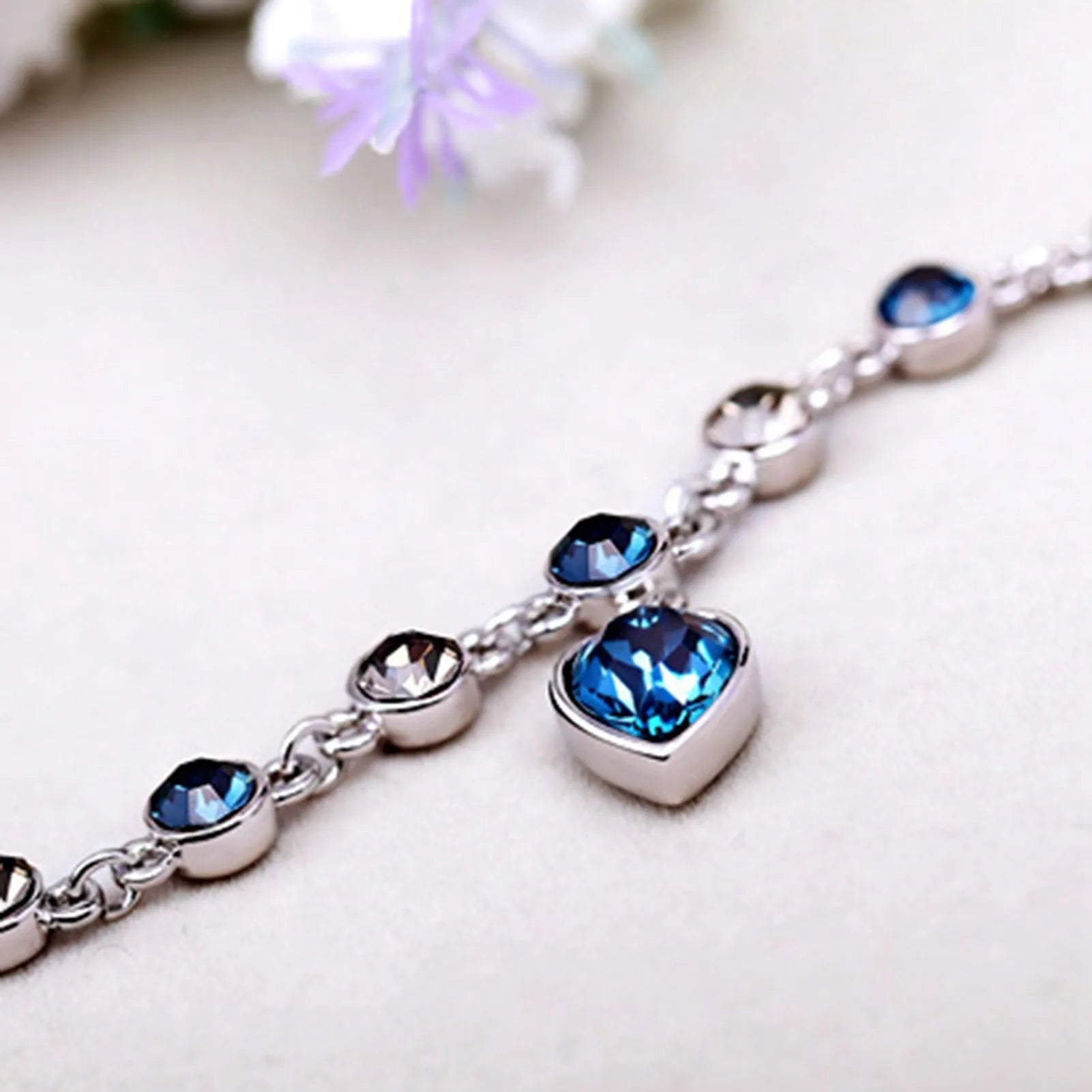 Adjustable sterling silver bracelet featuring azure cubic zirconia stones, designed with an ocean-inspired motif for comfortable wear. 3
