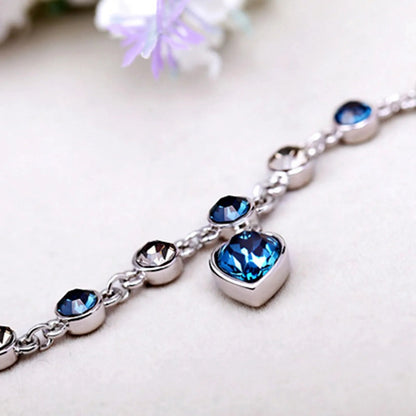 Adjustable sterling silver bracelet featuring azure cubic zirconia stones, designed with an ocean-inspired motif for comfortable wear. 3