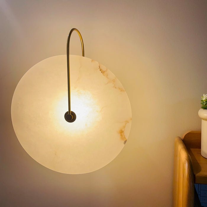 Alabaster wall lamp featuring integrated LED lighting and a unique snowflake pattern, designed with a modern minimalist aesthetic in black metal. 8